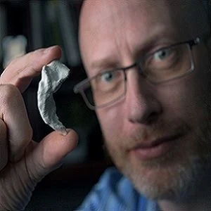 Neurobiologist Craig Stark holding a 3D model of his own hippocampus