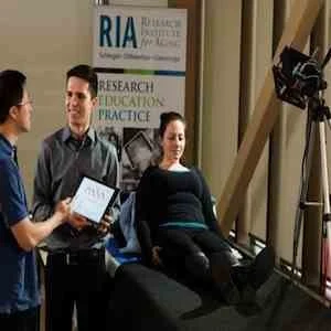 Professor Alexander Wong and Robert Amelard at the Schlegel-University of Waterloo Research Institute for Aging analyzing blood-flow data extracted with their new touchless device, pictured right. 