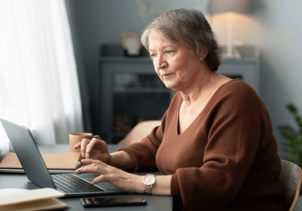 Senior woman using a laptop for telehealth services and online health management&nbsp;