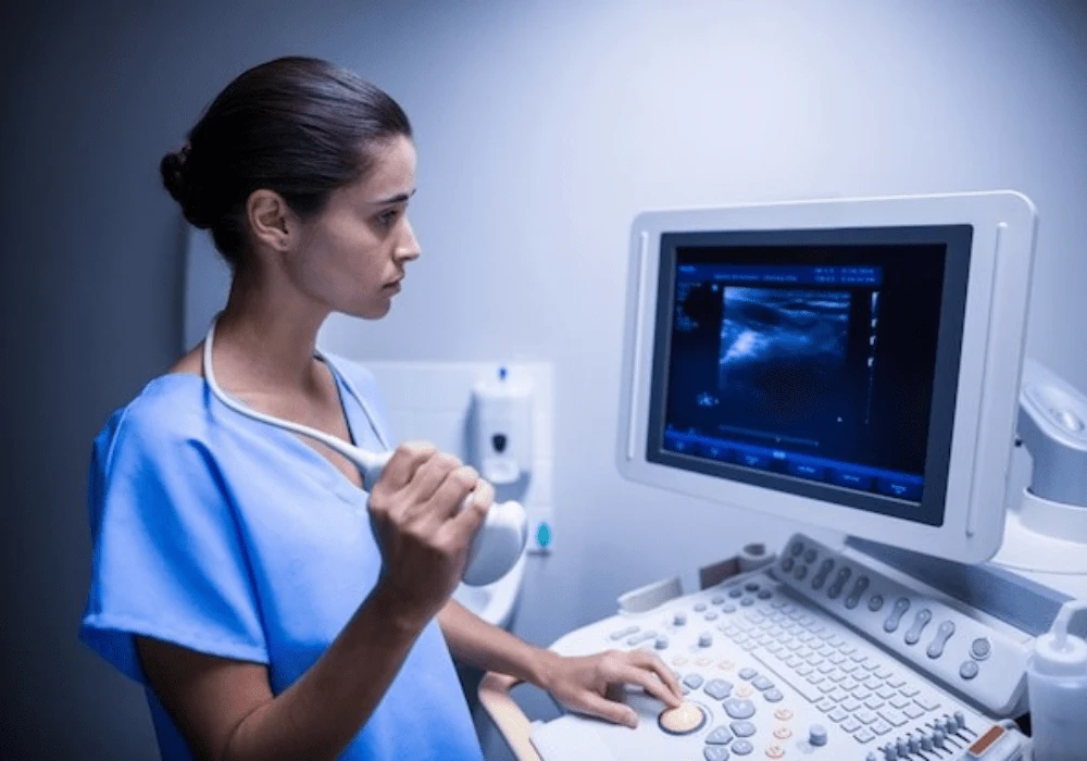 Nurse using ultrasound device for non-invasive patient diagnostics in a clinical setting&nbsp;