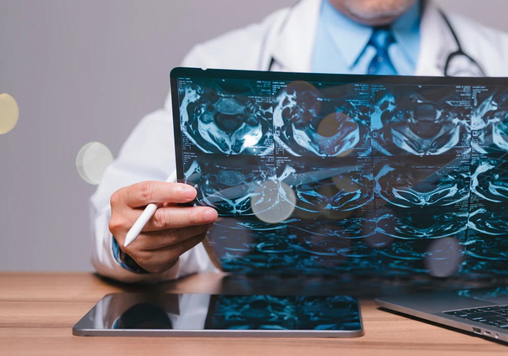 Doctor analysing MRI pelvic scans with stylus and digital devices, highlighting advanced radiology, medical imaging review and integration of digital health tools.&nbsp;