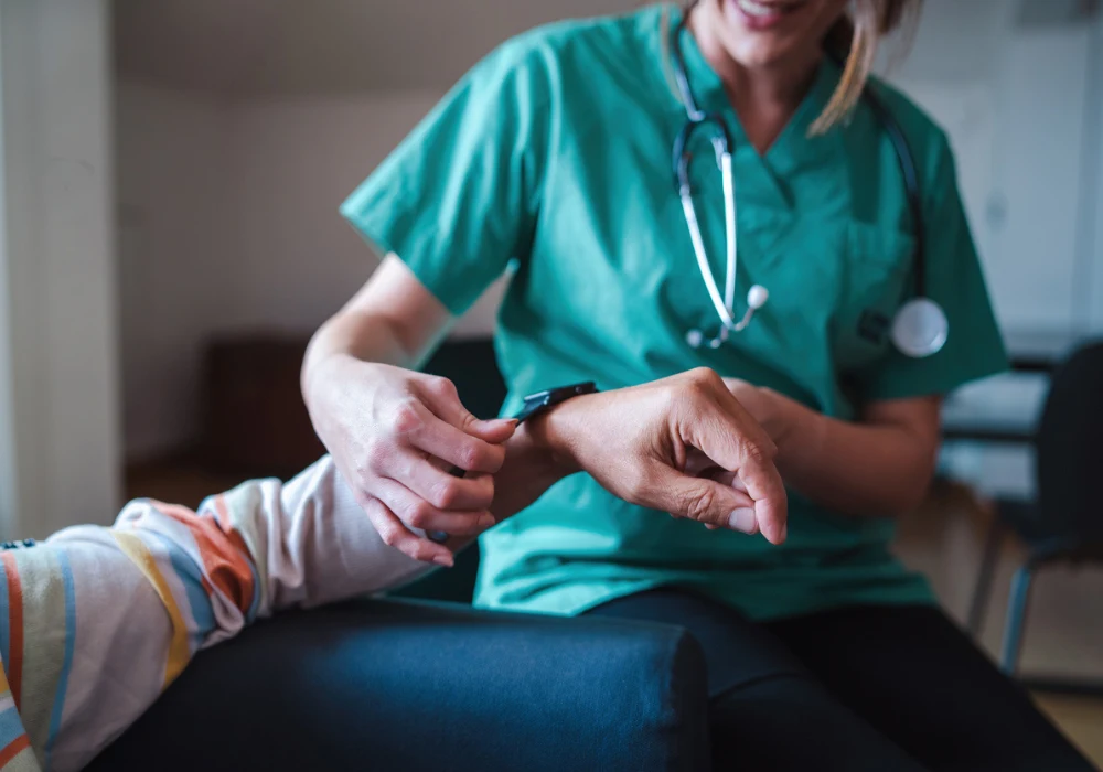 Nurse checking elderly patient&rsquo;s pulse at home, providing personalised healthcare and monitoring vital signs.&nbsp;