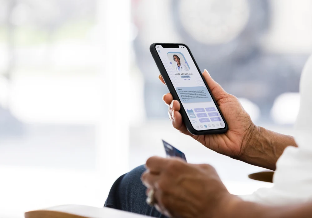 Patient using telehealth app on smartphone to consult with doctor and manage healthcare online&nbsp;