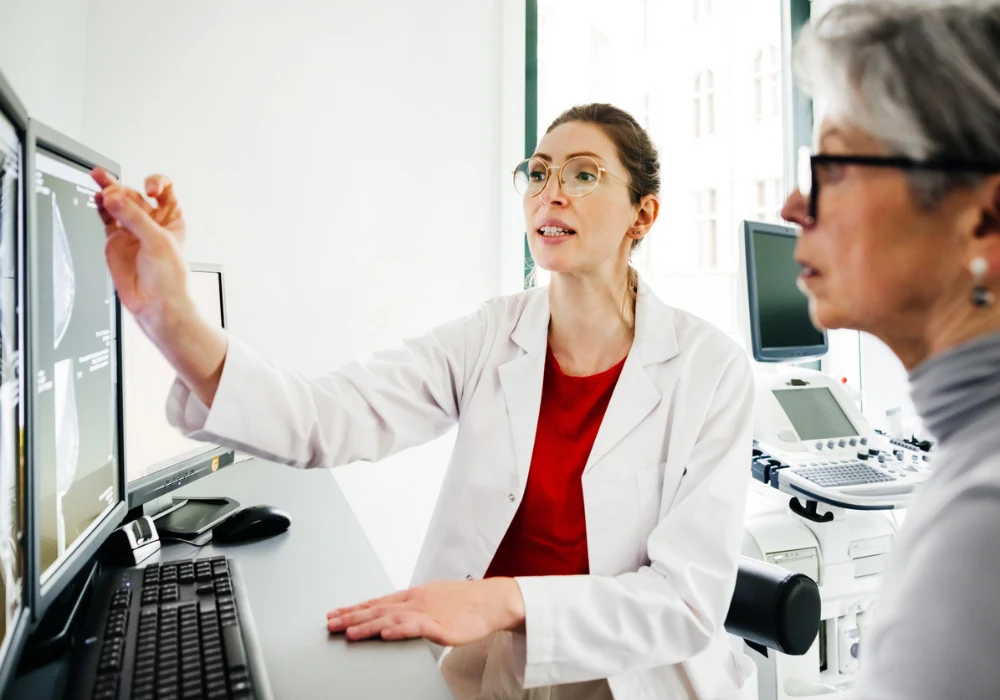 Doctor reviewing diagnostic imaging results with senior female patient during consultation&nbsp;