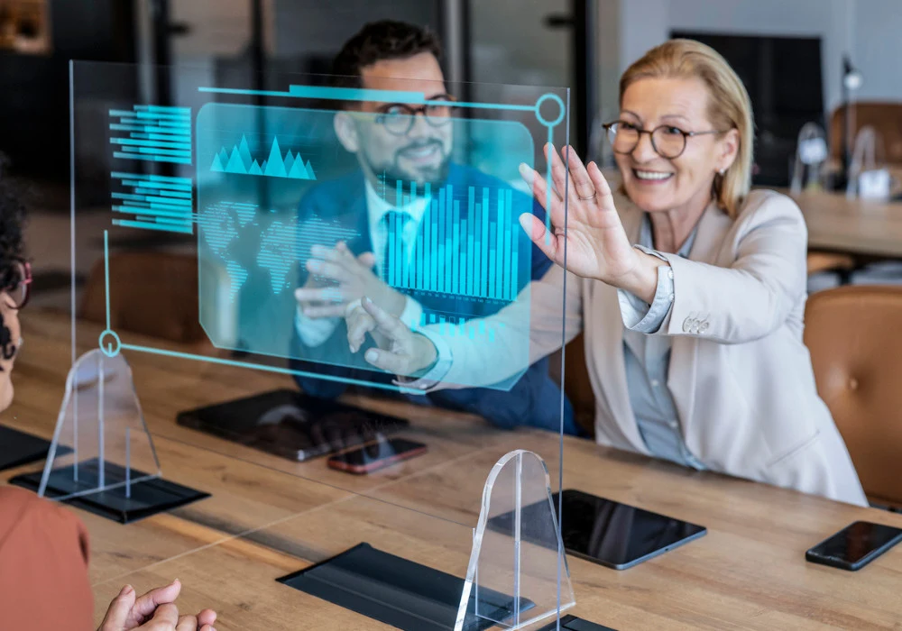 Business professionals interacting with futuristic digital holographic interface during meeting&nbsp;