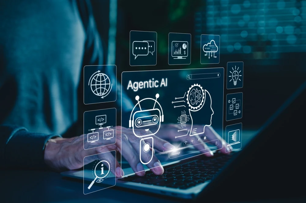 Agentic AI interface with autonomous digital agents over a laptop, illustrating enterprise automation and workflow orchestration.&nbsp;