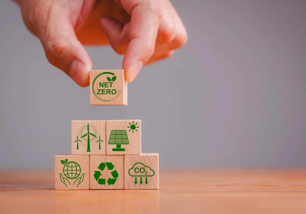 Net zero healthcare concept with wind, solar, recycling and CO2 icons on wooden blocks.&nbsp;