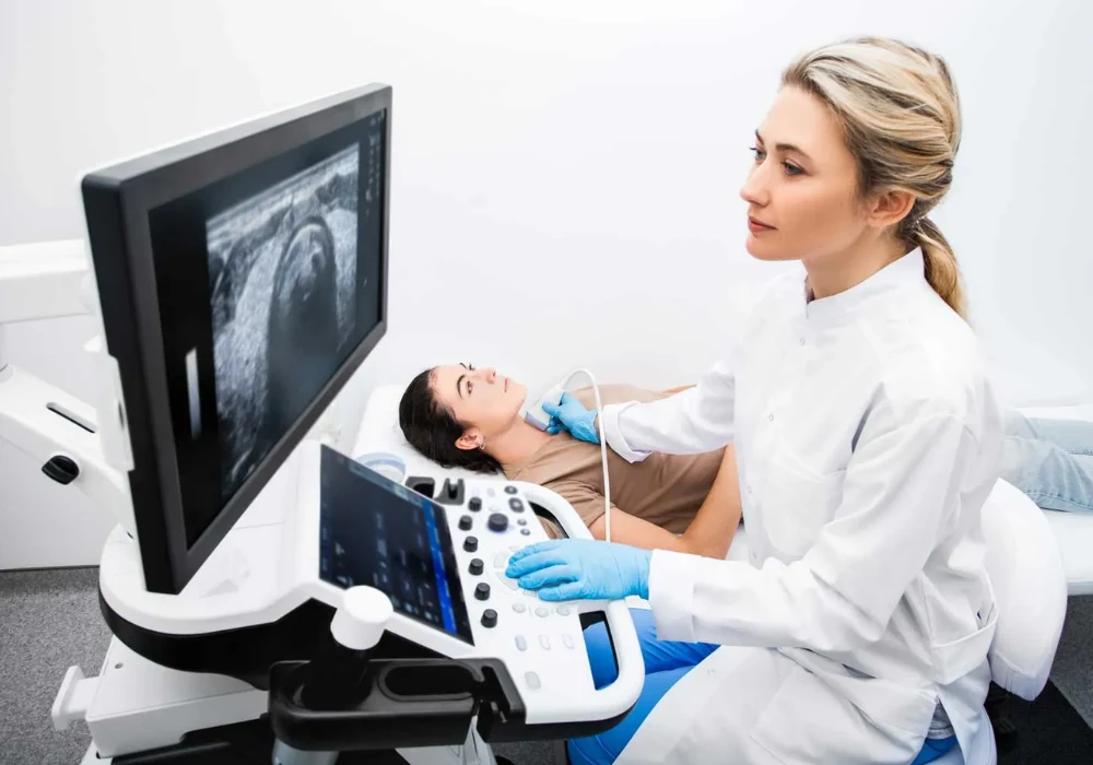 Female patient undergoing an abdominal ultrasound examination performed by a clinician using a modern ultrasound system to assess internal organs.&nbsp;