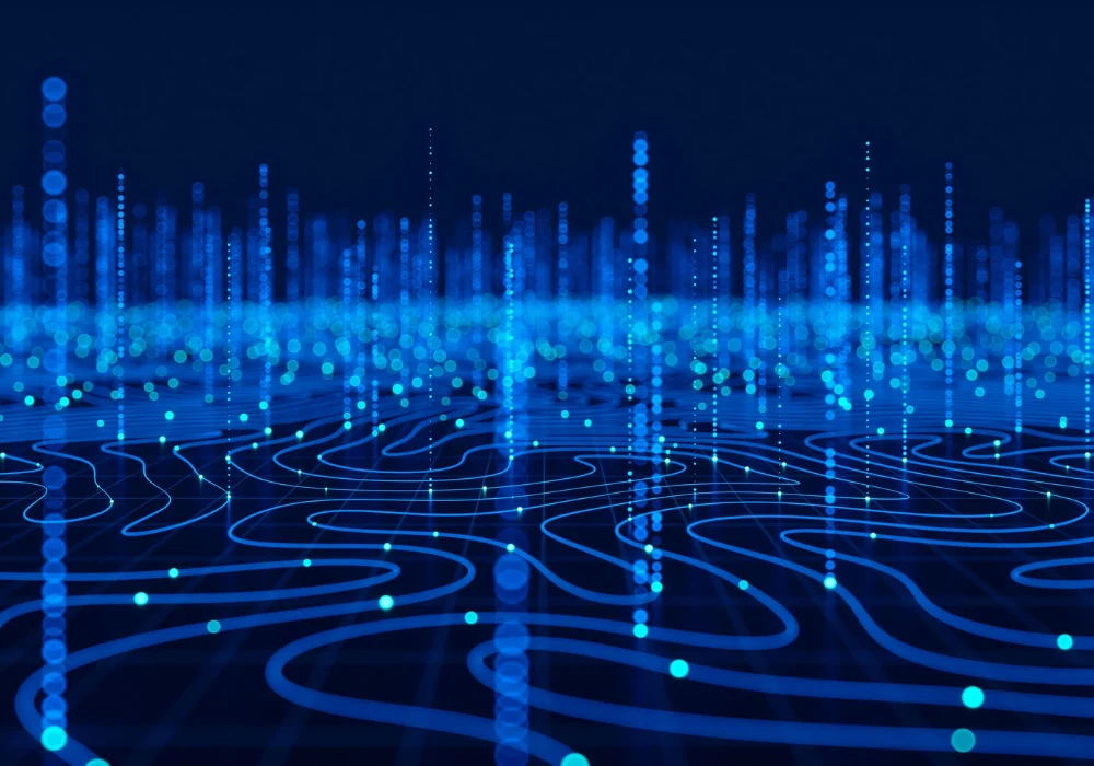 A glowing blue digital landscape with flowing grid lines and vertical data points,&nbsp;representing&nbsp;data networks, information&nbsp;streams&nbsp;and advanced technology&nbsp;visualisation.&nbsp;