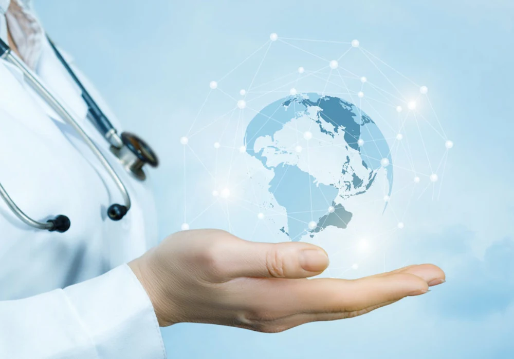 Doctor&rsquo;s hand presenting a holographic globe with network links,&nbsp;symbolising&nbsp;global healthcare.&nbsp;