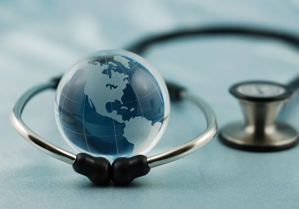 Glass globe inside stethoscope representing global healthcare, international medical collaboration and worldwide public health initiatives.&nbsp;