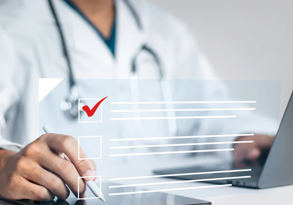 Physician ticking digital checklist to document care and safety.&nbsp;