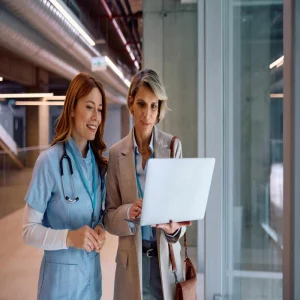 A clinician and a hospital administrator review data on a laptop&nbsp;