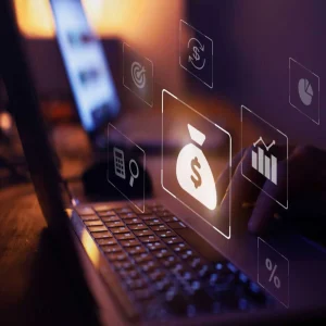 Close-up of a person working on a laptop with digital finance and analytics icons symbolizing financial planning, investment&nbsp;analysis&nbsp;and business growth.&nbsp;