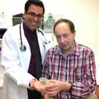 Dr. Jamil Aboulhosn and patient Richard Whitaker hold the 3D printed model of the patient&rsquo;s heart.