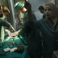 a wounded man being treated in a field hospital in Syria