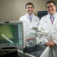 Jeffrey Nix, M.D., left, and Soroush Rais-Bahrami, M.D., with the iSR&rsquo;obot Mona Lisa, a new image-guided device for diagnosing prostate cancer prostate cancer