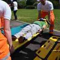 Emergency medicine technicians stretchering a patient