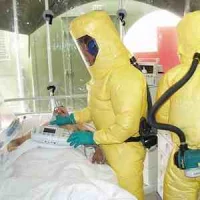 Patient in isolation with Ebola virus being cared for by nurses in protective gear