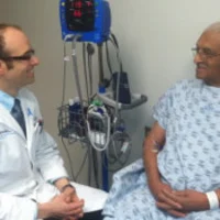 Dr Robert Den with a prostate cancer patient in 2013