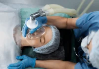 Nurse Assisting Patient with Oxygen Mask &ndash; Emergency Medical Care and Respiratory Support