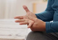 Close-up of a senior person experiencing hand pain, arthritis or joint discomfort at home&nbsp;