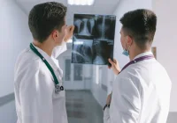 Doctor examining spinal and pelvic X-rays for diagnosis, showcasing radiographic imaging used in musculoskeletal assessments and orthopaedic care.&nbsp;