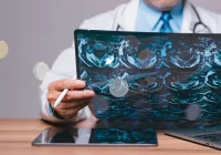 Doctor analysing MRI pelvic scans with stylus and digital devices, highlighting advanced radiology, medical imaging review and integration of digital health tools.&nbsp;