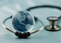 Glass globe inside stethoscope representing global healthcare, international medical collaboration and worldwide public health initiatives.&nbsp;