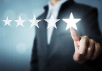Business professional giving five-star rating for customer satisfaction and service excellence online&nbsp;