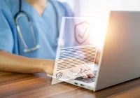 Doctor using laptop with secure digital health records interface symbolising data protection in healthcare IT&nbsp;