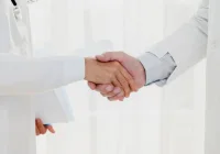 Doctors shaking hands symbolising healthcare collaboration, partnership and professional trust&nbsp;