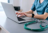 Healthcare professional using laptop for digital patient records and telemedicine support&nbsp;