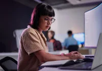 Female software developer working at modern workstation in tech office environment&nbsp;
