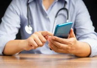 Doctor using smartphone for digital health communication and telemedicine services&nbsp;