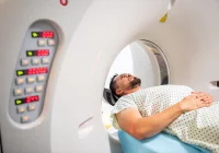 Male patient undergoing CT scan lying inside computed tomography scanner in hospital&nbsp;