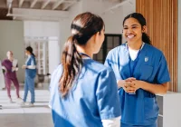 Hospital nurses in discussion, illustrating psychological safety and teamwork for patient safety.&nbsp;