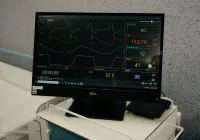 Hospital monitoring screen displaying multiple patient vital signs and ECG data, representing real-time intensive care monitoring.&nbsp;