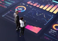 &nbsp;Two business professionals review large digital data dashboards with charts and maps.&nbsp;