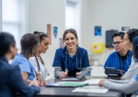 Hospital care team discusses cases during a multidisciplinary huddle.&nbsp;