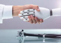 Clinician and robot shake hands, symbolising AI collaboration in healthcare.&nbsp;