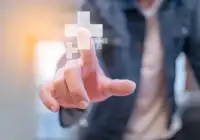 Man touching virtual medical cross icon for digital health and healthcare access&nbsp;