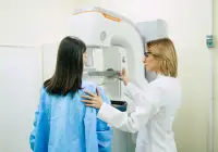 Mammogram screening procedure with patient and doctor using mammography machine