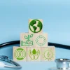 Sustainable healthcare concept illustrated with eco-icons on wooden blocks, highlighting environmental responsibility, circular economy principles and resource efficiency in health systems.