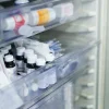 Hospital medication refrigerator with organised vials and supplies, illustrating controlled storage and inventory management in clinical pharmacy settings.