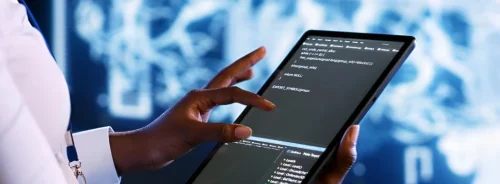 Clinician using a tablet with medical data, representing health IT, clinical analytics and digital innovation.