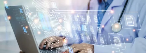 Doctor reviews AI-supported patient data on a laptop.