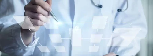Clinician reviewing a digital workflow diagram, illustrating structured clinical processes and healthcare decision pathways.