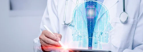 Clinician using a tablet with an AI head visualisation, illustrating artificial intelligence in diagnostics, clinical decision support and digital healthcare innovation.