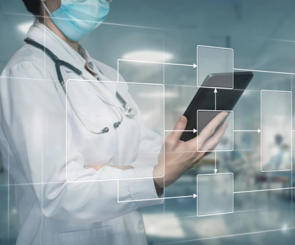 Doctor using digital healthcare workflow diagram, supporting care coordination, process mapping, interoperability and clinical data management.